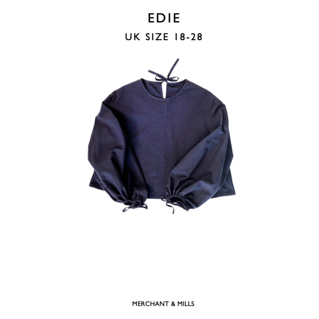 Navy blue blouse with balloon sleeves on a white background, labeled 'EDIE' and 'Merchant & Mills'.