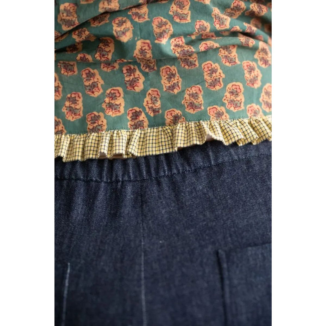 Navy blue skirt with floral patterned top section on a white background