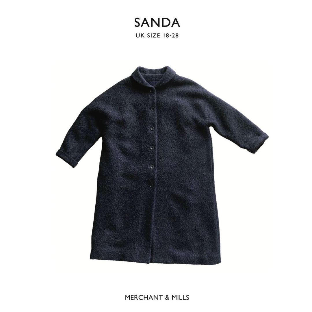 Dark gray coat on a white background with 'SANDA' and 'Merchant & Mills' branding.