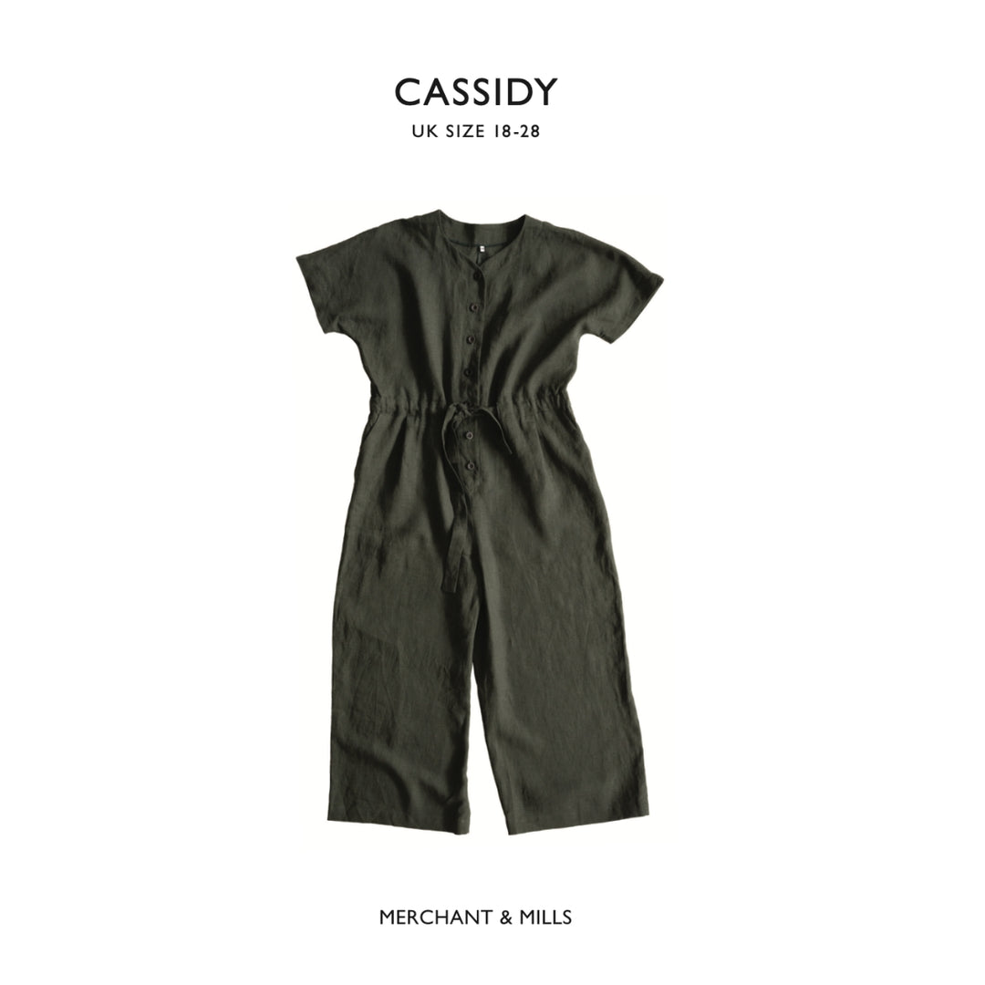 Green jumpsuit on a white background with 'CASSIDY' and 'MERCHANT & MILLS' branding.