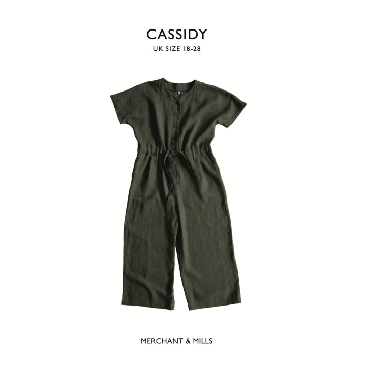 Green jumpsuit on a white background with 'CASSIDY' and 'MERCHANT & MILLS' branding.
