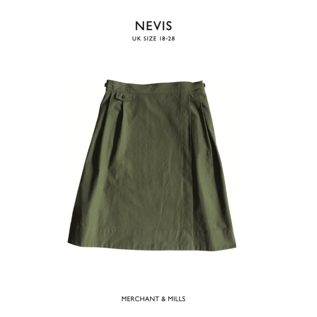 Green skirt with 'Nevis' and 'Merchant & Mills' branding on a white background