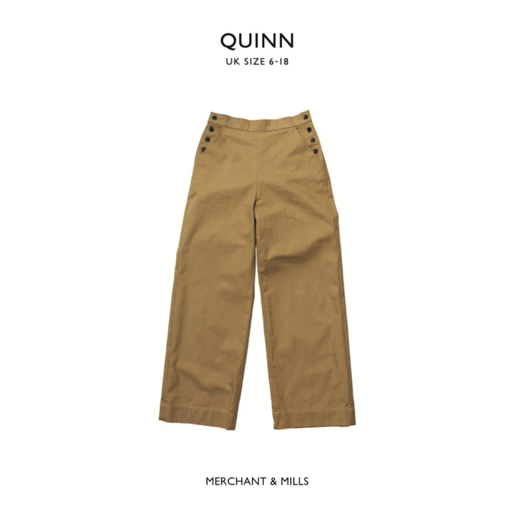 A pair of wide-leg trousers in camel brown, featuring decorative dark buttons on the waistband, shown against a plain white background with brand text 'QUINN' at the top and 'MERCHANT & MILLS' at the bottom.
