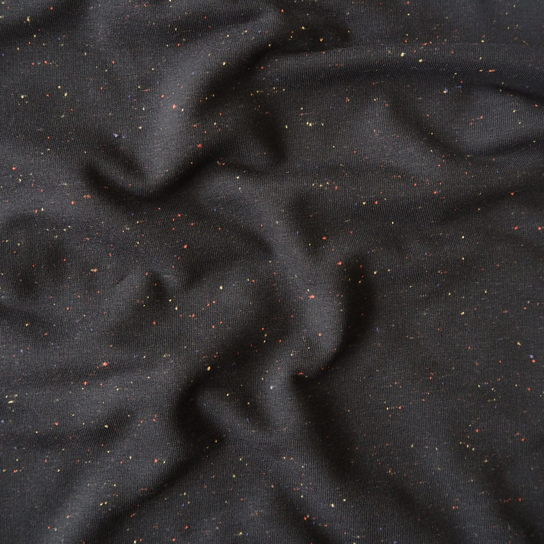 Black fleeceback sweatshirt fabric with subtle colourful flecks.