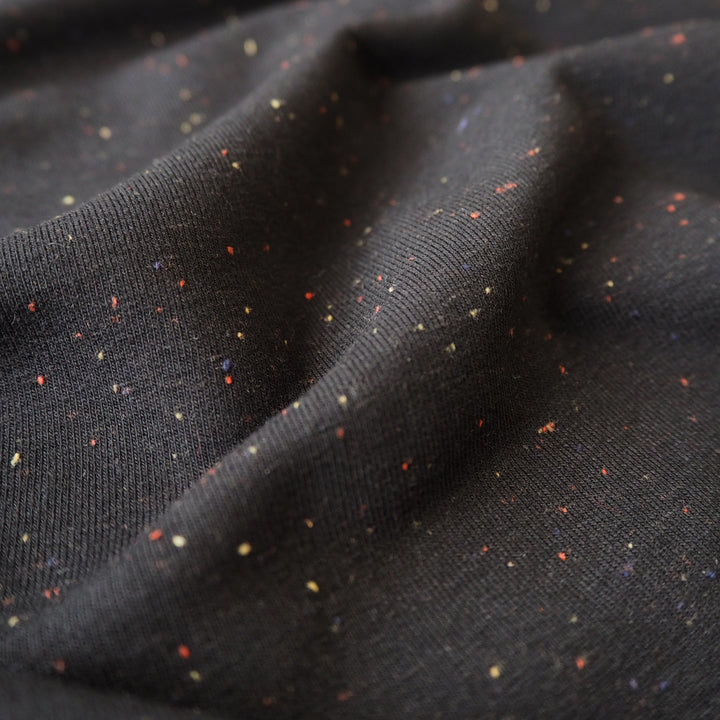 Black fleeceback sweatshirt fabric with subtle colourful flecks.