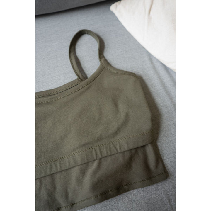 Green sports bra on a gray surface