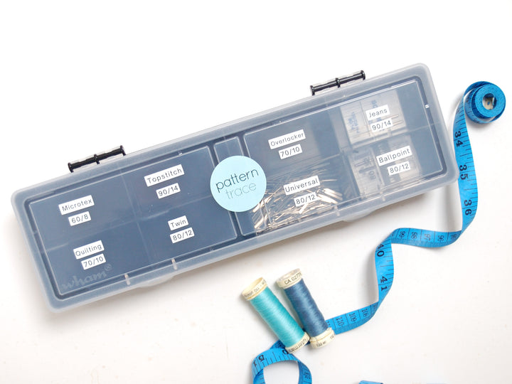 Pattern Studio organizer with spools of thread and a measuring tape on a white background