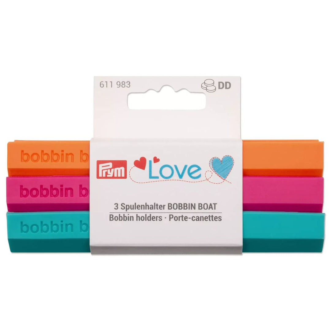 Set of colorful bobbin holders with Prym branding on a white background