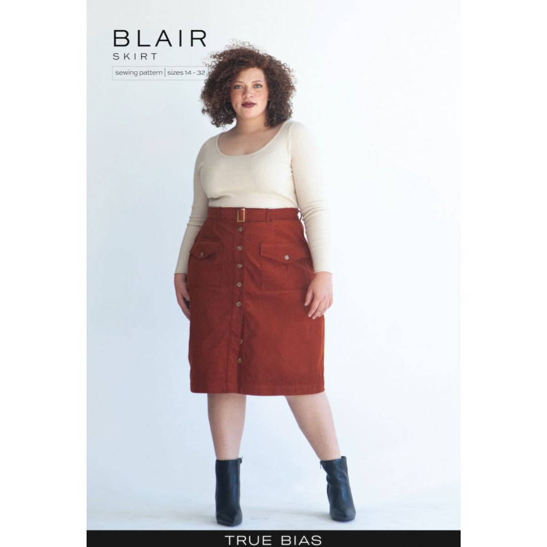 Model wearing a red skirt with buttons, standing against a white background, with 'Blair Skirt' text above.