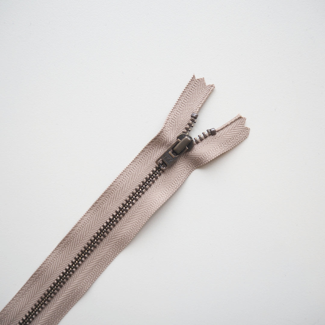 Beige zipper on a light gray background