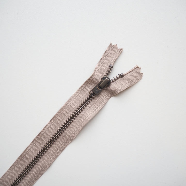 Beige zipper on a light gray background