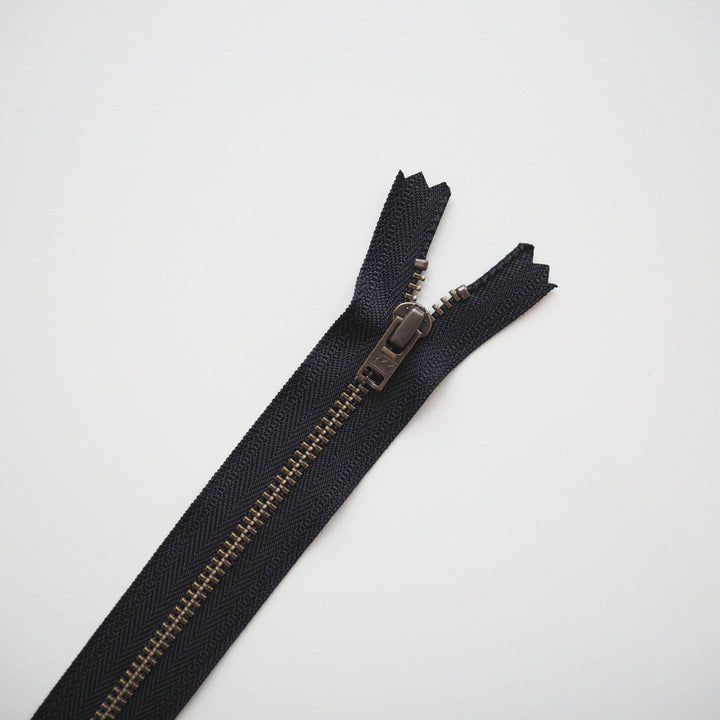 Black zipper on a light gray background