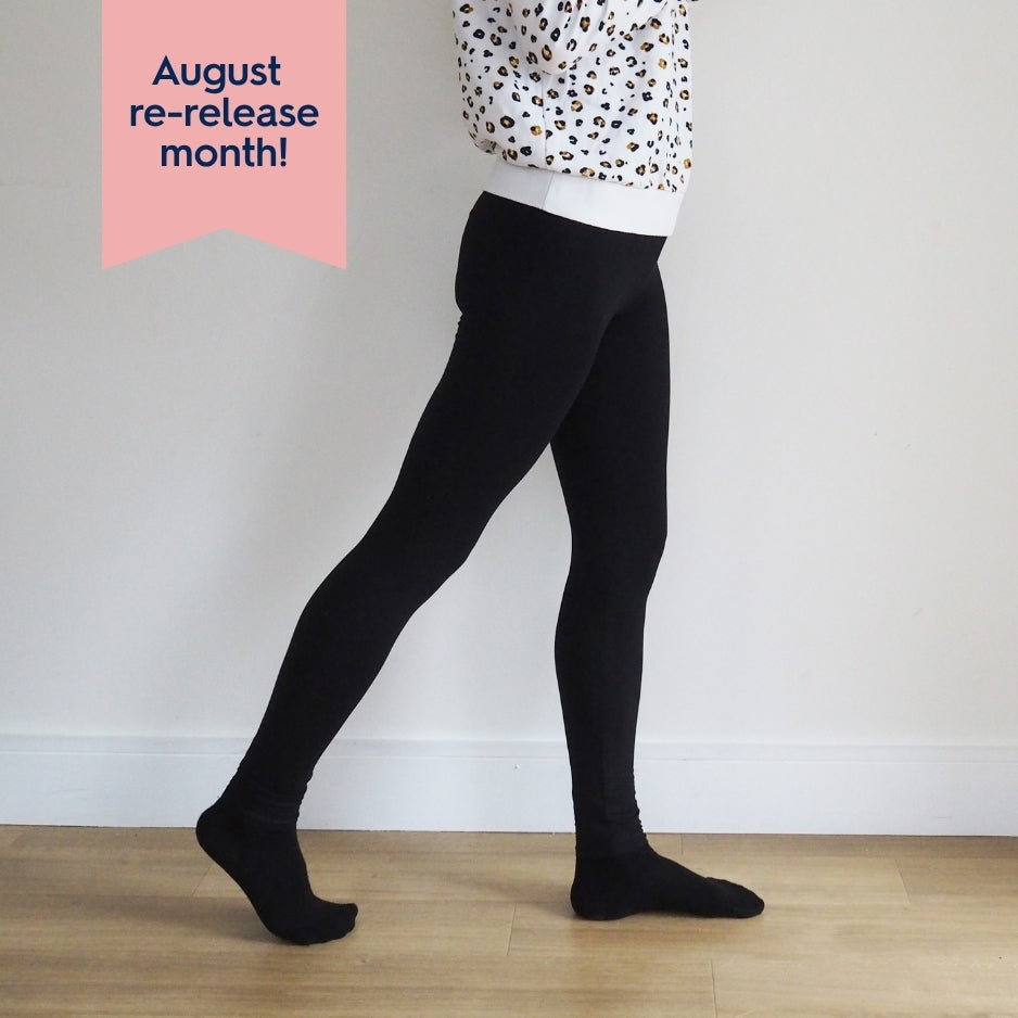 Person wearing black tights with a white background
