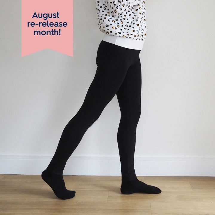 Person wearing black tights with a white background