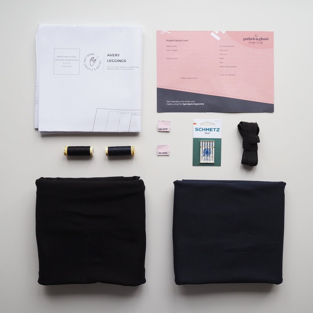 Fabric, thread, and design tools on a white surface