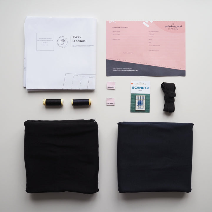 Fabric, thread, and design tools on a white surface