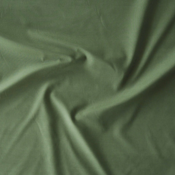 Close-up of green fabric with folds