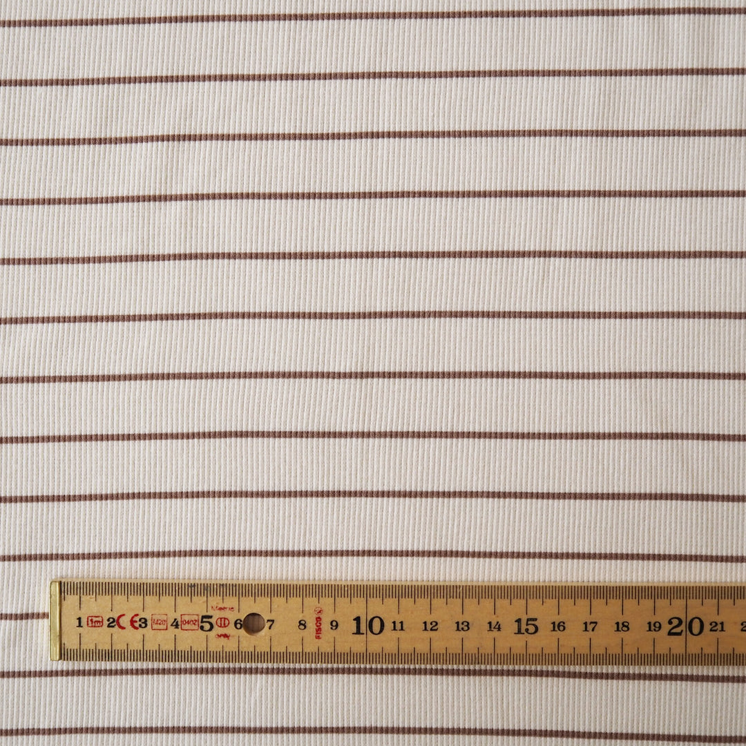Striped ribbed cotton jersey fabric with brown lines on a beige background