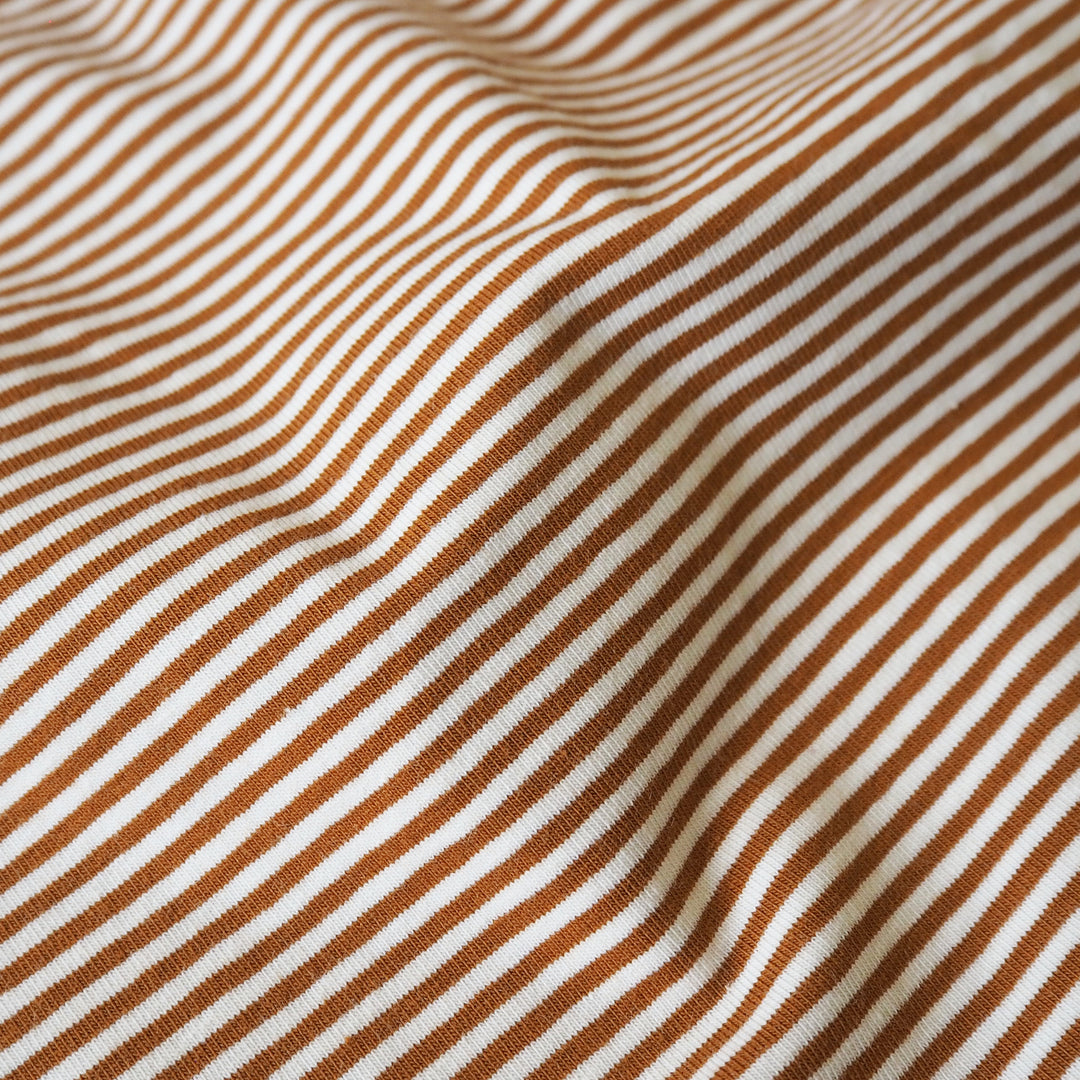 Striped cotton jersey fabric with brown-orange and white stripes