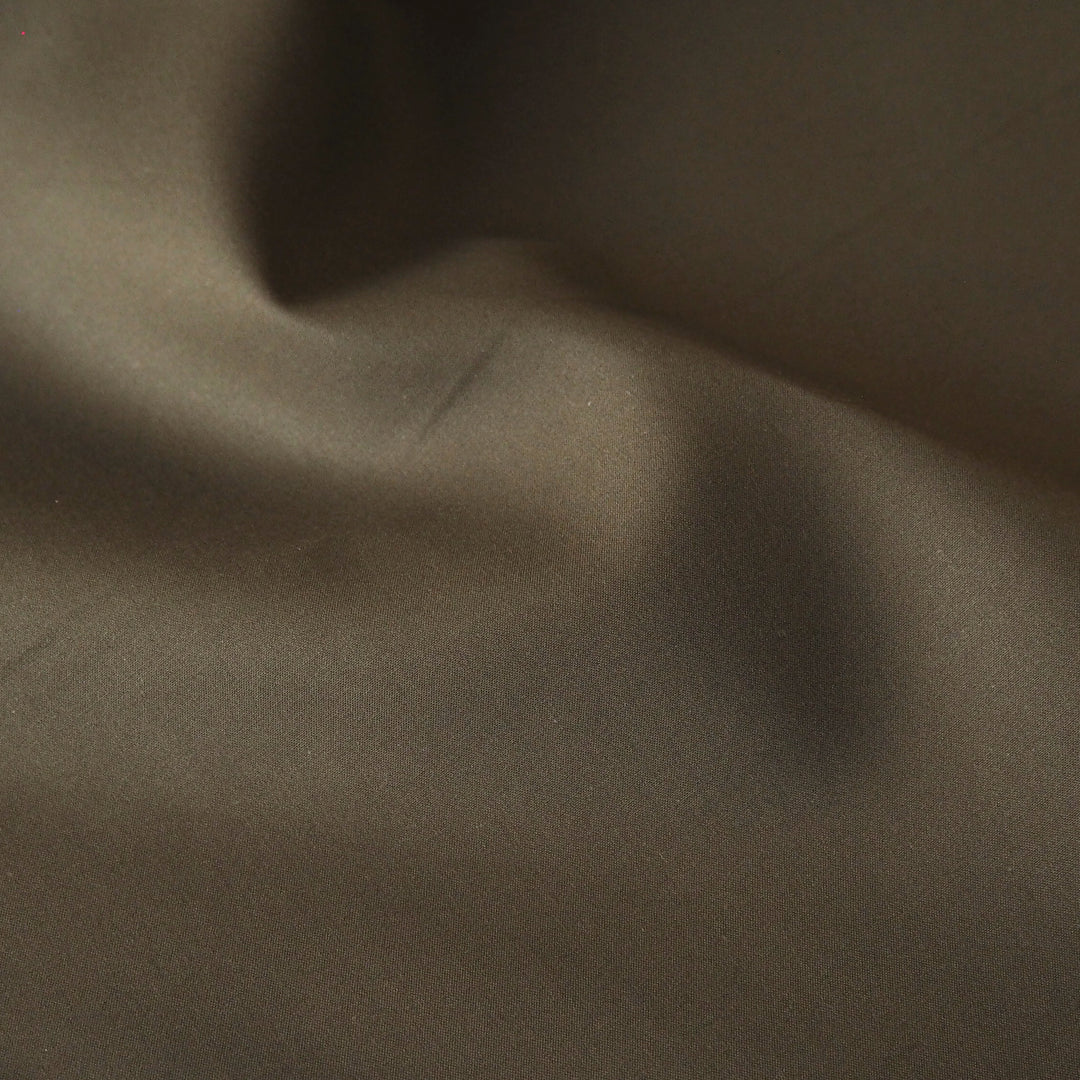 Khaki waxed cotton fabric with water-resistant finish for outerwear sewing.