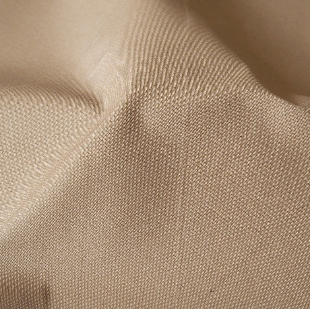 Sand waxed cotton fabric with water-resistant finish for outerwear sewing.