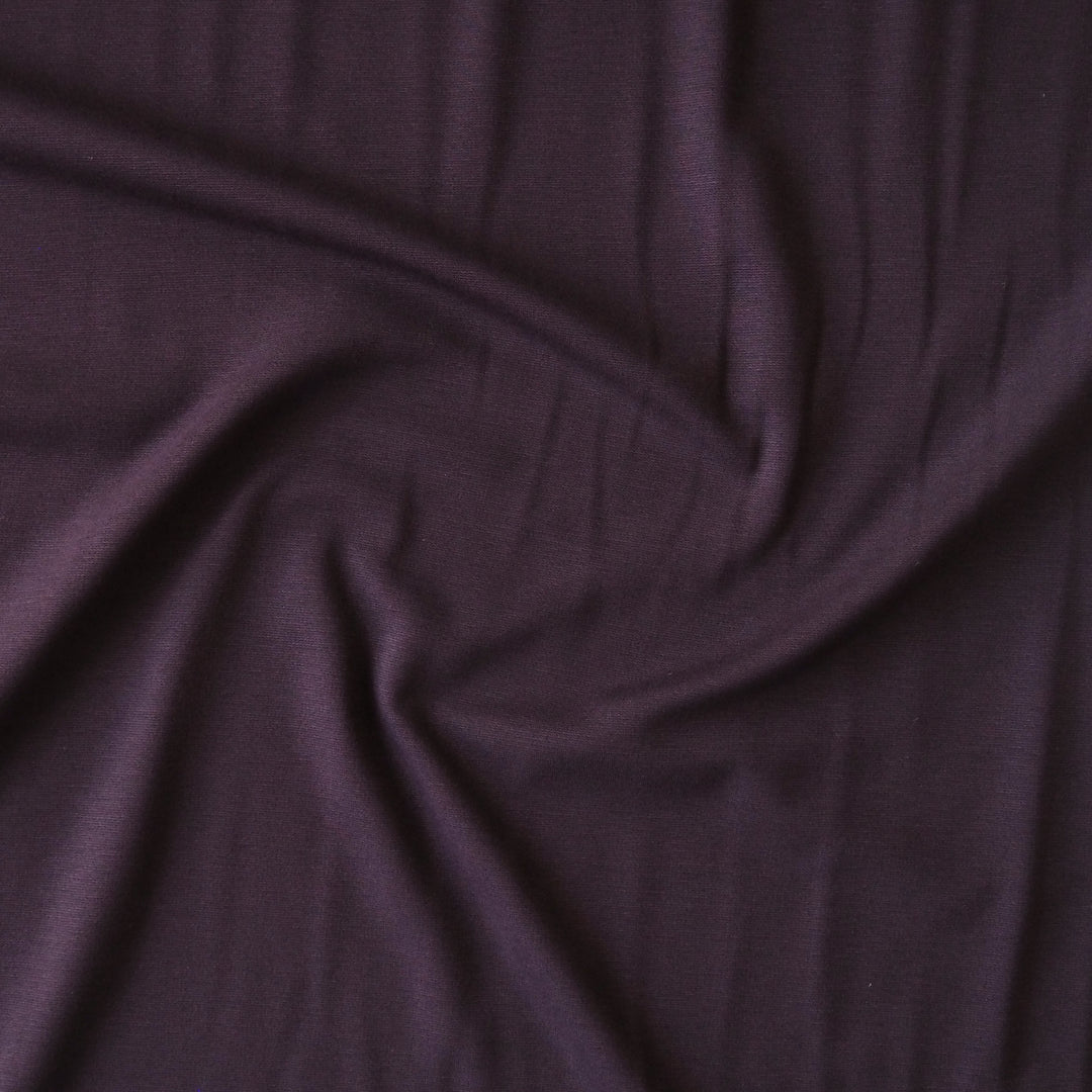 Plum light viscose ponte fabric with soft stretch for dressmaking.