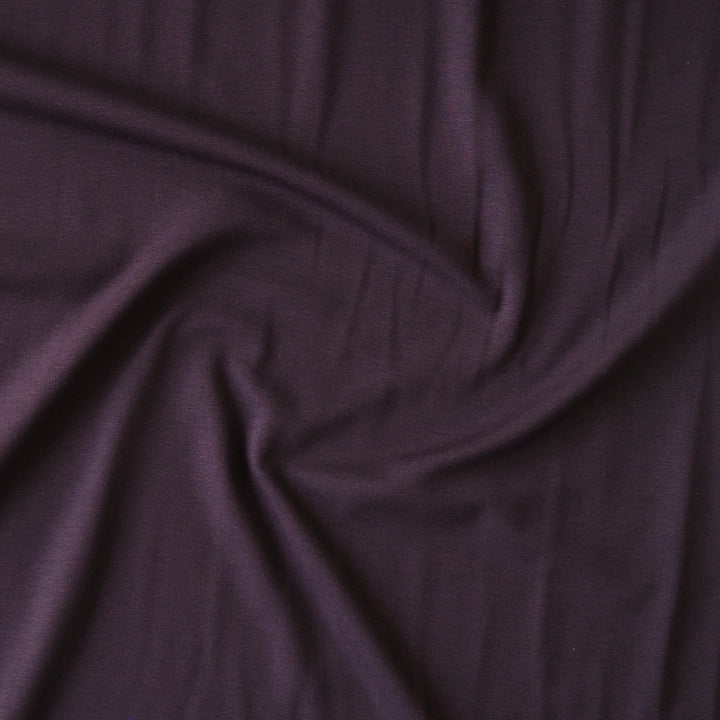 Plum light viscose ponte fabric with soft stretch for dressmaking.