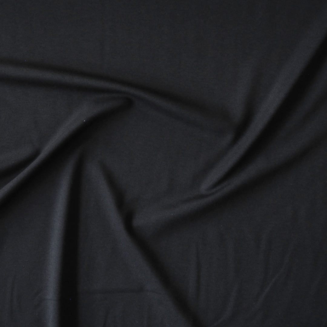 Black viscose ponte jersey fabric for dressmaking.