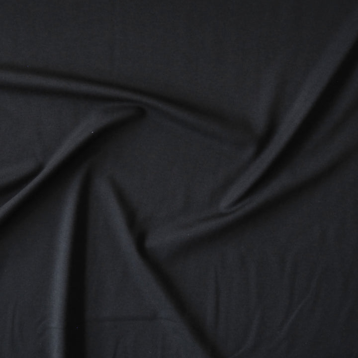 Black viscose ponte jersey fabric for dressmaking.