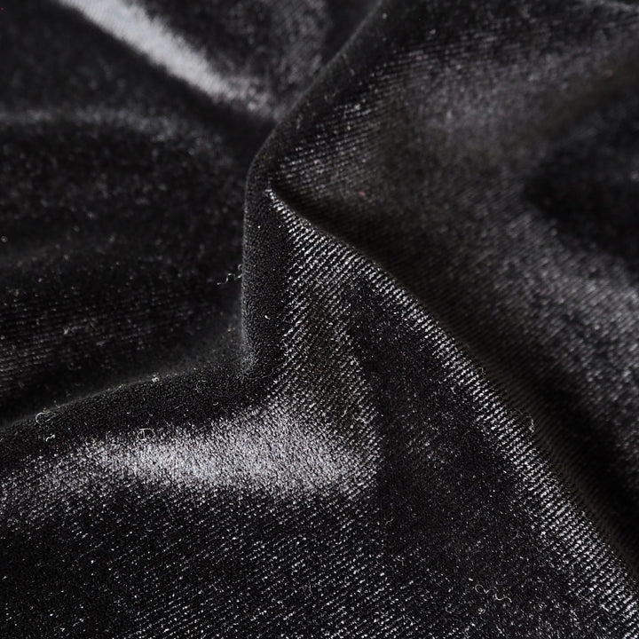 Black stretch velour fabric with soft sheen for dressmaking.