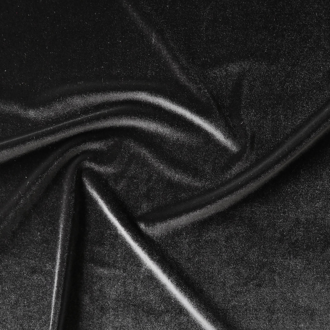 Black stretch velour fabric with soft sheen for dressmaking.