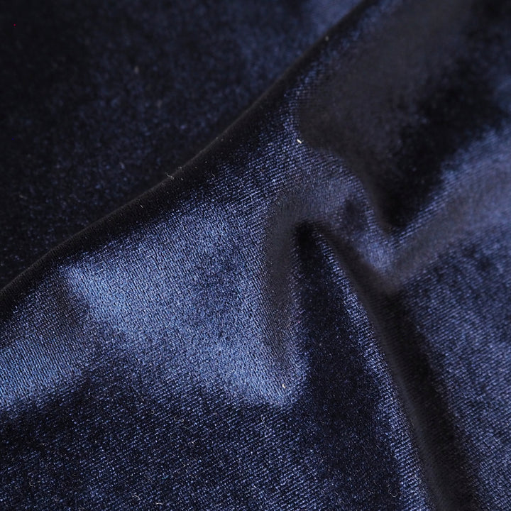 Navy blue stretch velour fabric with soft sheen for dressmaking.