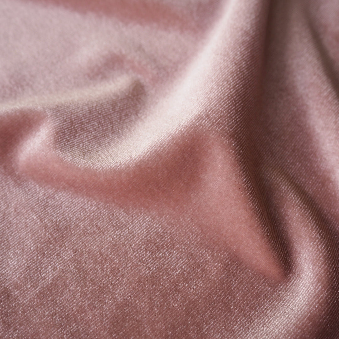 Rose pink stretch velour fabric with soft sheen for dressmaking.