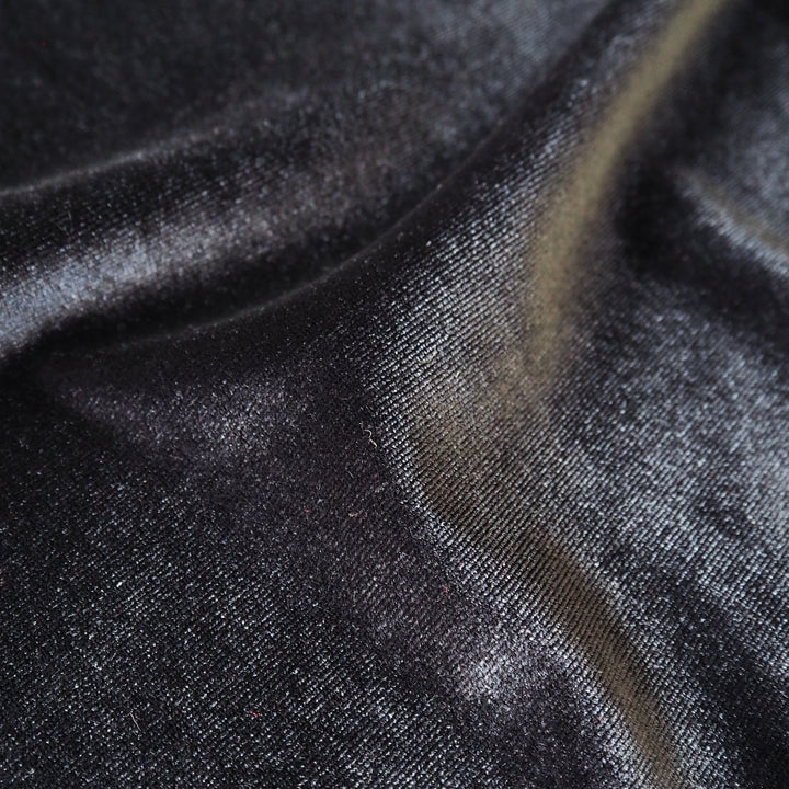 Charcoal grey stretch velour fabric with soft sheen for dressmaking.