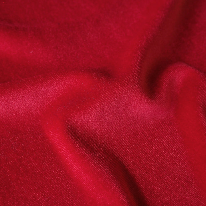 Scarlet red stretch velour fabric with soft sheen for dressmaking.