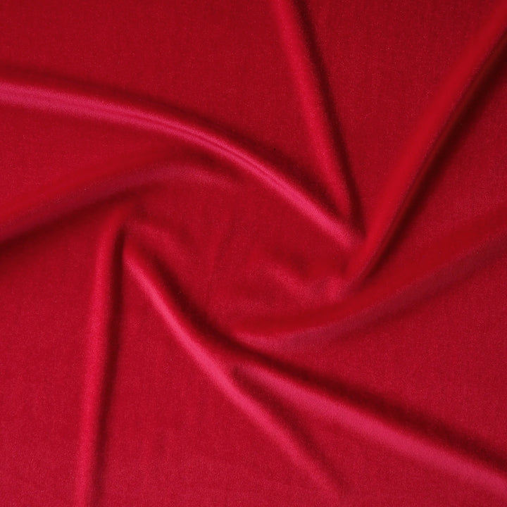 Scarlet red stretch velour fabric with soft sheen for dressmaking.