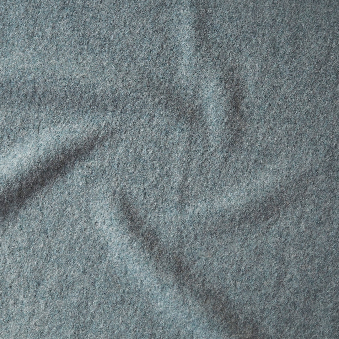 Close up of textured seafoam green boiled wool fabric