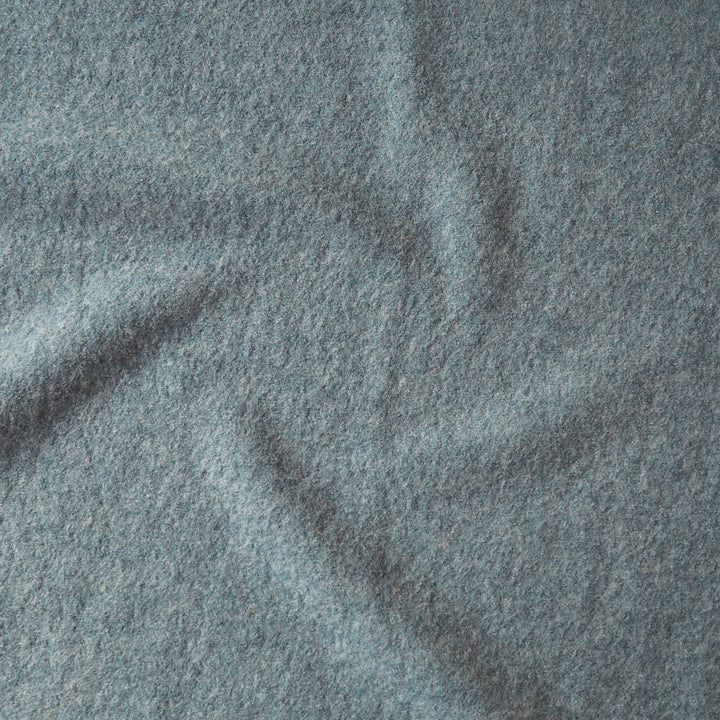 Close up of textured seafoam green boiled wool fabric