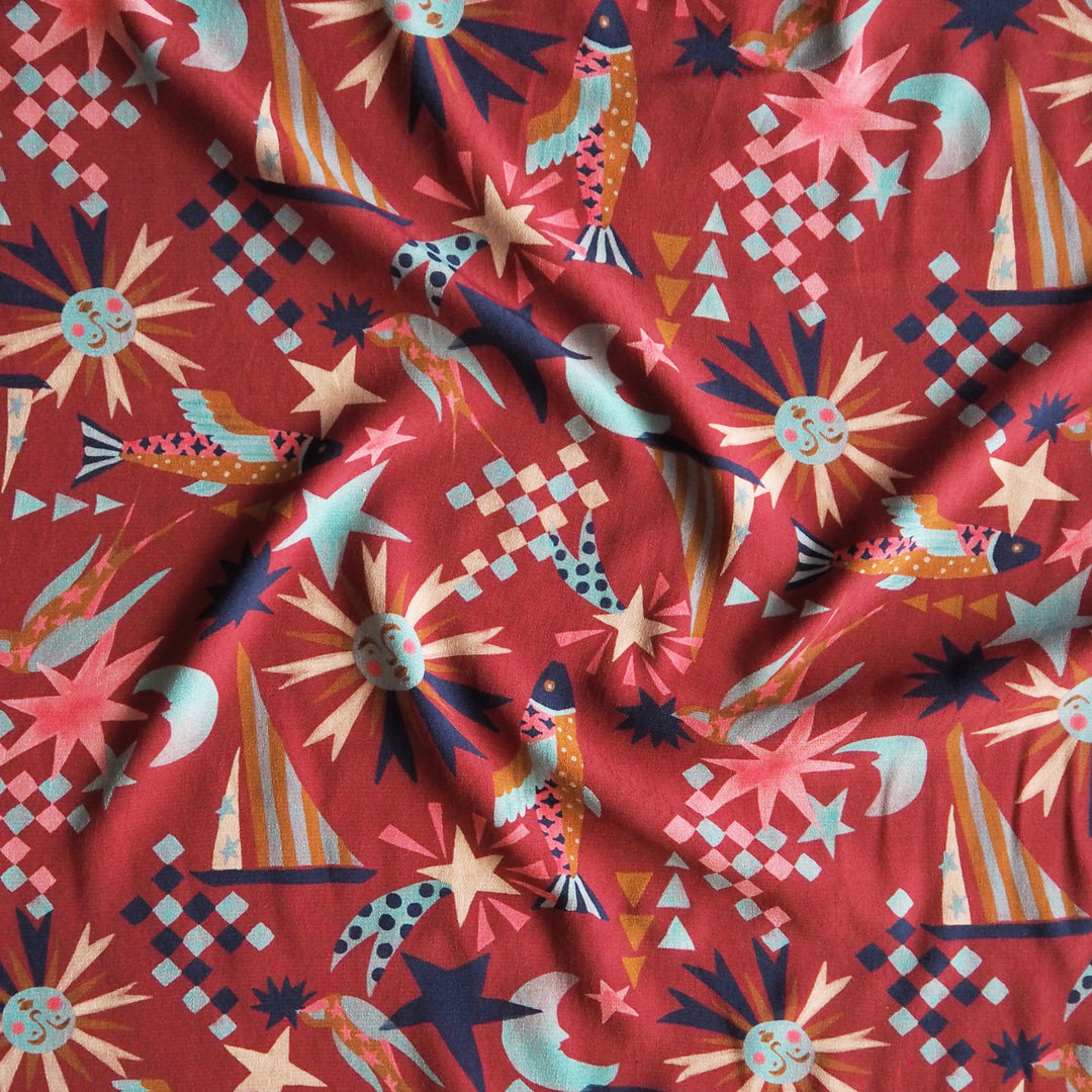 Fabric Godmother Soleil Maroon Viscose Crepe Fabric – maroon viscose crepe with celestial print