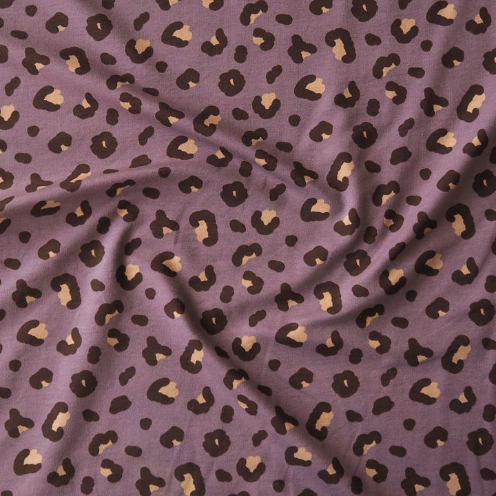 Purple cotton french terry fabric with brown and beige leopard print pattern