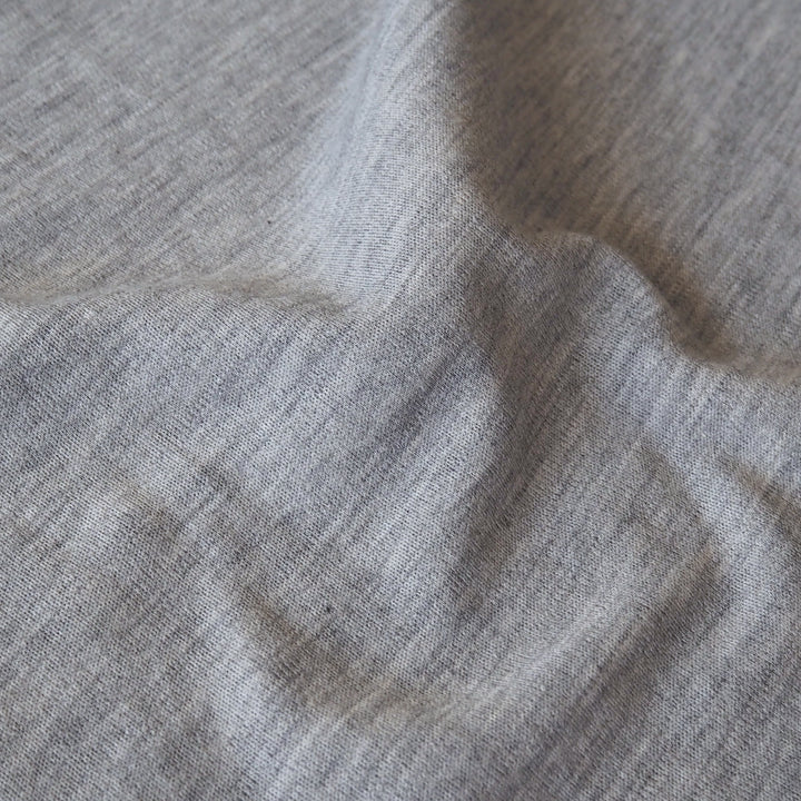 Close-up of grey merino wool jersey fabric with visible texture