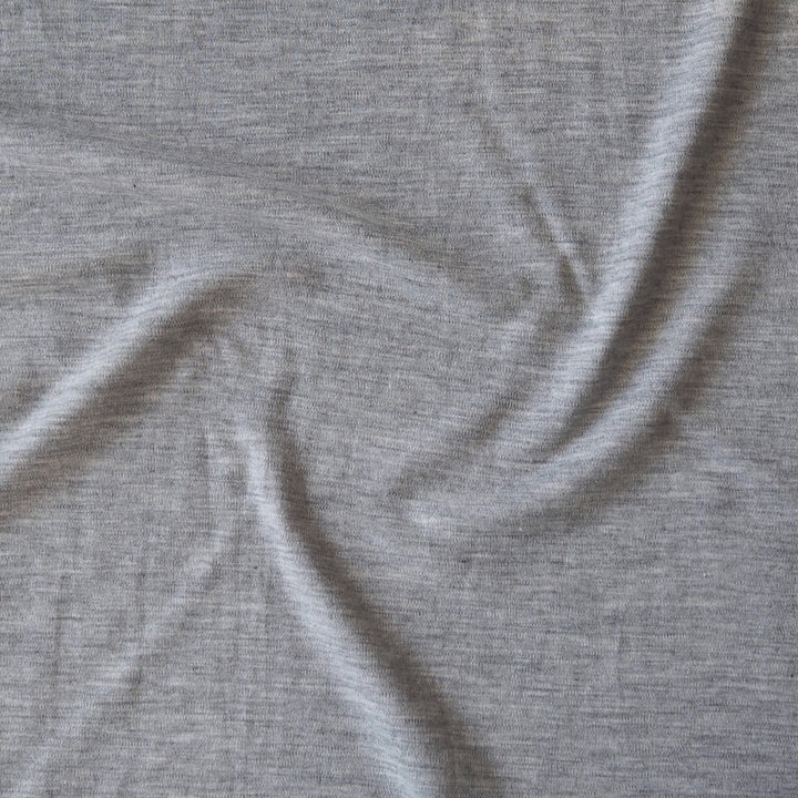 Close-up of grey merino wool jersey fabric with visible texture