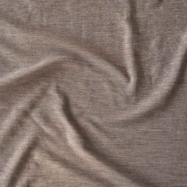 Close-up of beige merino wool jersey fabric with visible texture