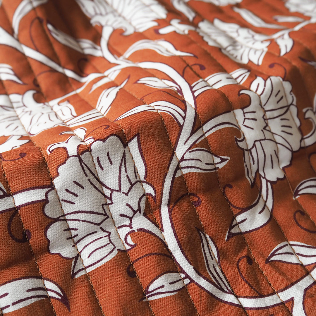 Terracotta Garden reversible quilted cotton fabric with rust floral design