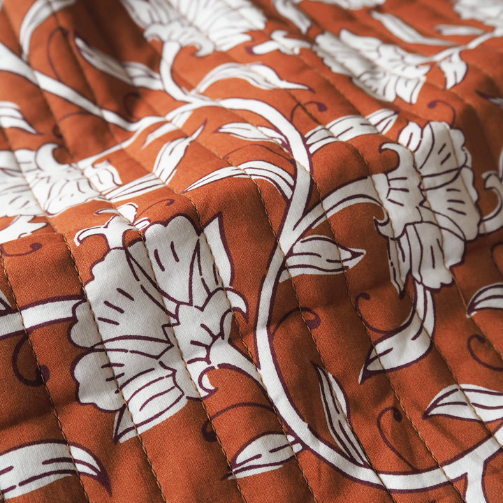 Terracotta Garden reversible quilted cotton fabric with rust floral design