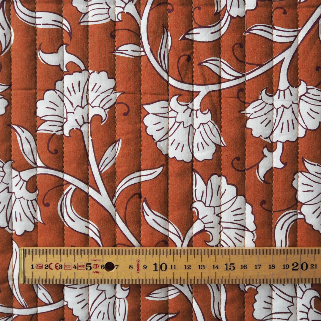 Terracotta Garden reversible quilted cotton fabric with rust floral design