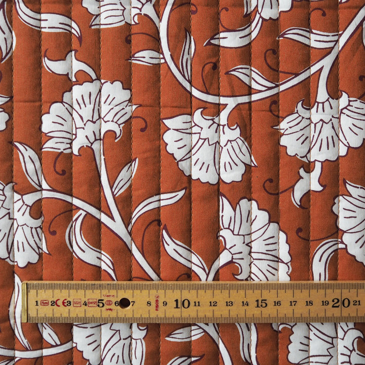 Terracotta Garden reversible quilted cotton fabric with rust floral design