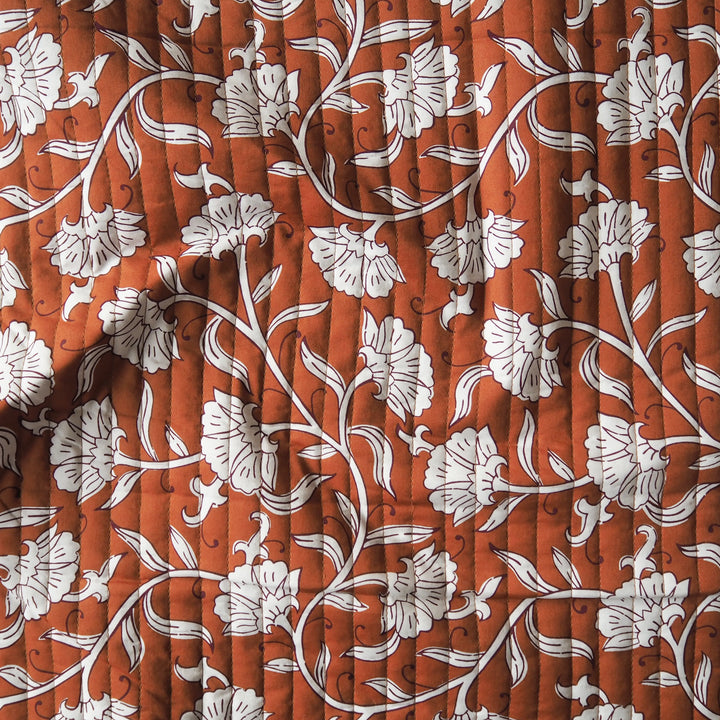 Terracotta Garden reversible quilted cotton fabric with rust floral design
