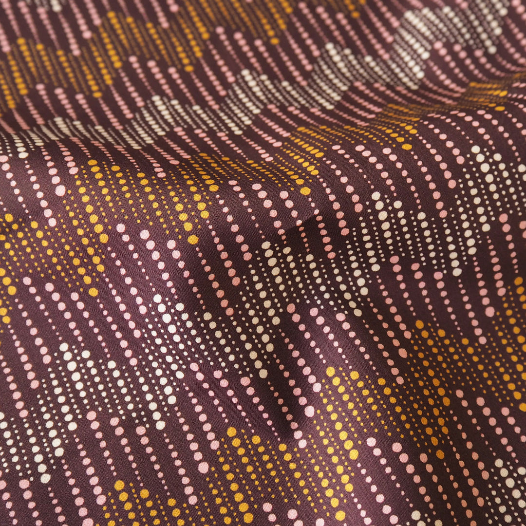 Liberty fabric with a subtle spotted chevron pattern on a plum background