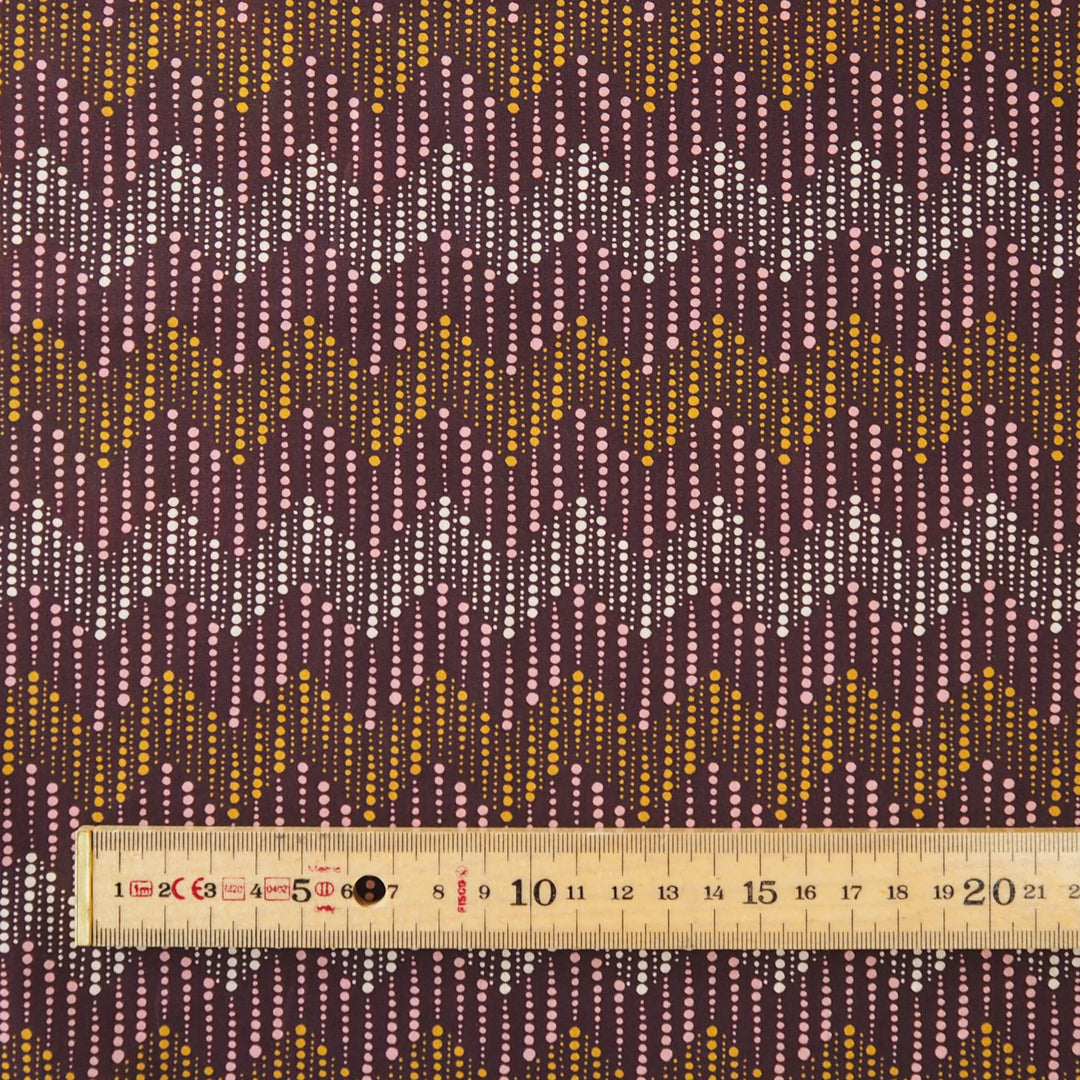 Liberty fabric with a subtle spotted chevron pattern on a plum background